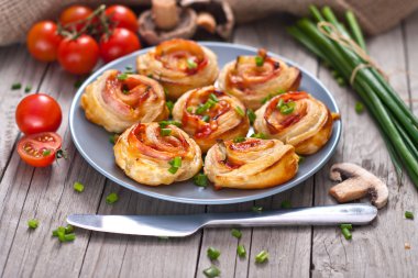 Puff pastry rolls with ham and chese. Baked snacks