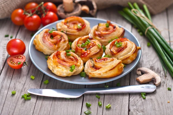 Rolos de massa folhada com presunto e queijo. Petiscos assados — Fotografia de Stock