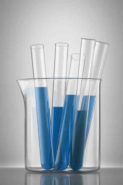 Chemical flask with a blue laboratory test tubes inside, isolate — Stock Photo, Image