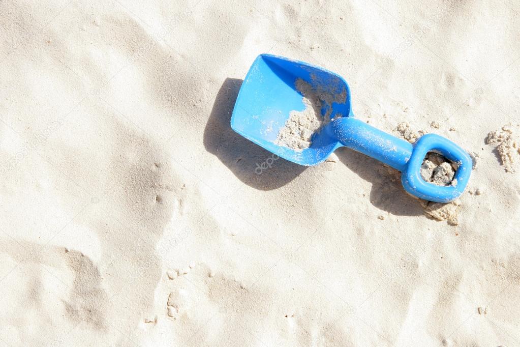 Blue childrens spade on the sandy beach, Aruba