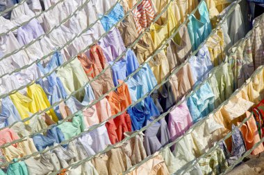 Colourful shirts hanging to dry at Dhobi Ghats central laundry, Mumbai, India. clipart