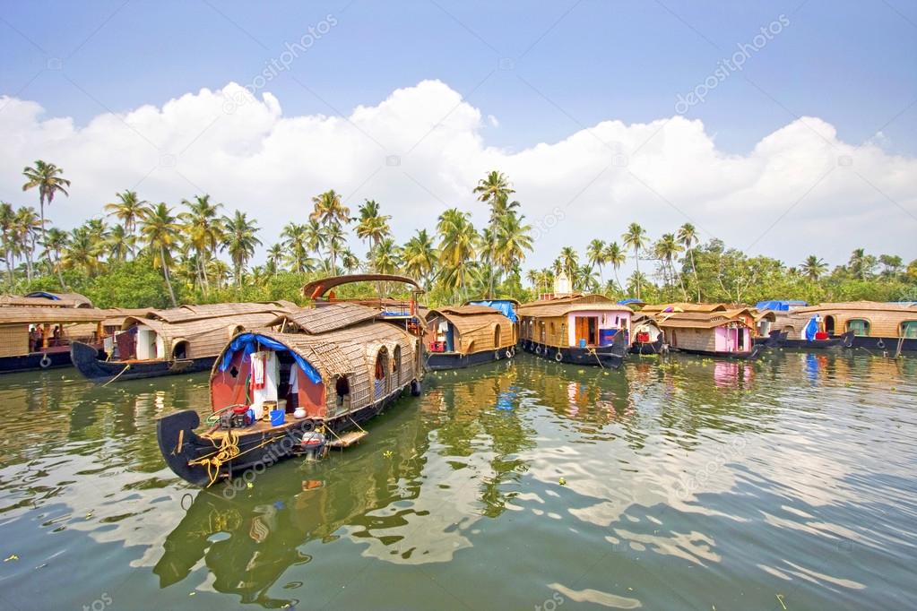 Traditional House boats moored together along the banks of the backwaters of Alleppey, Kerala, India.