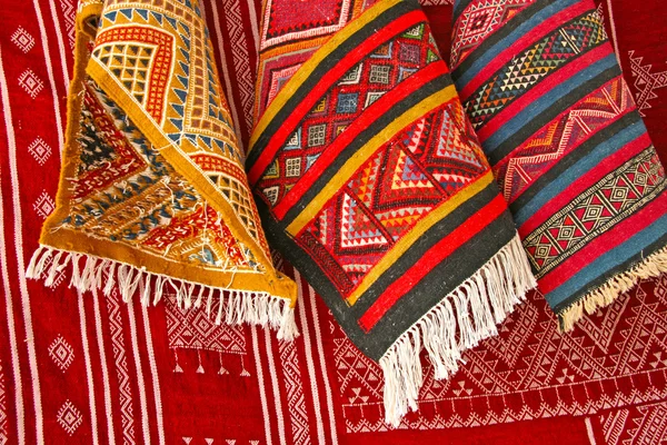 Pile of north african rugs in red, orange & brown shades, Morocc — Stock Photo, Image