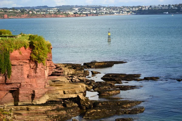 Red cliff rocks on the coast — Stock Photo, Image