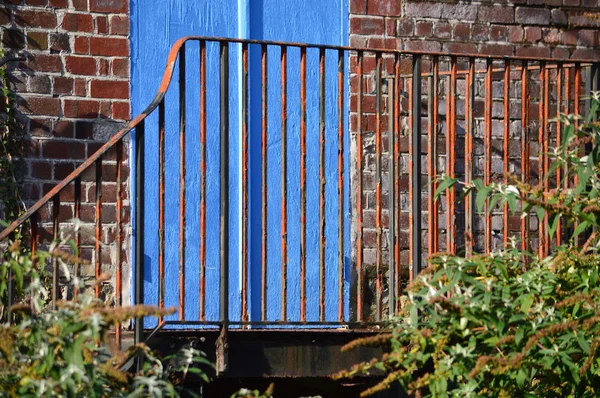 Rusty Railings in front of Blue Door — Stock Photo, Image