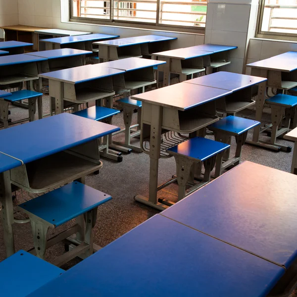 Leeg klaslokaal met stoelen, bureaus en schoolbord. — Stockfoto