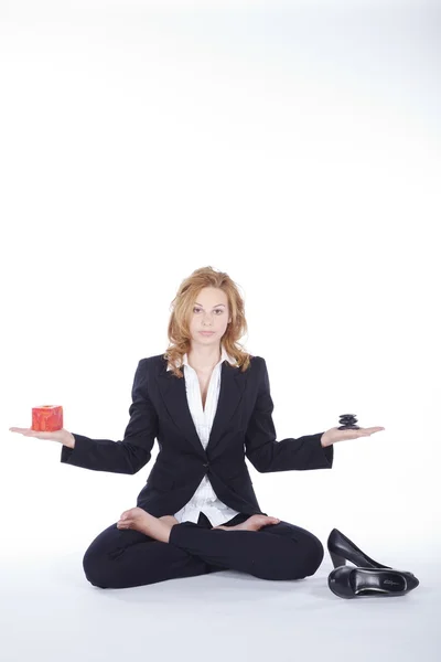 Zakenvrouw meditatie met cadeau en stenen op witte achtergrond — Stockfoto