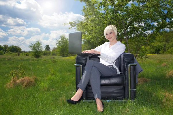 Businesswoman working on laptop in the landscape — Stock Photo, Image