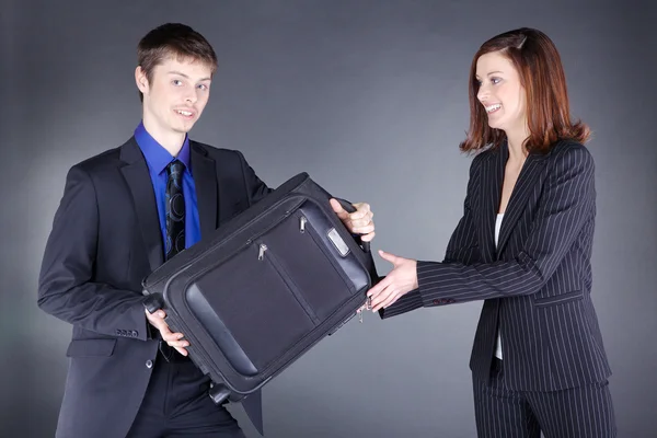 Business couple with suitcase — Stock Photo, Image