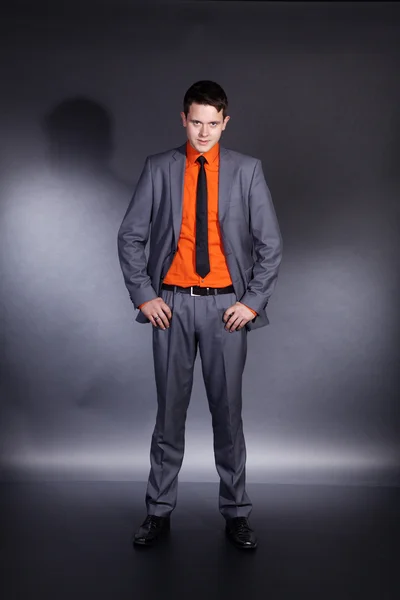 A young boy stands on a black background — Stock Photo, Image