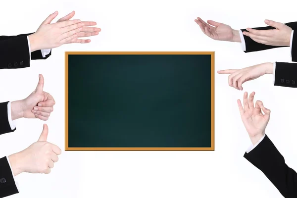 Hands of businessmen show signs near blackboard — Stock Photo, Image