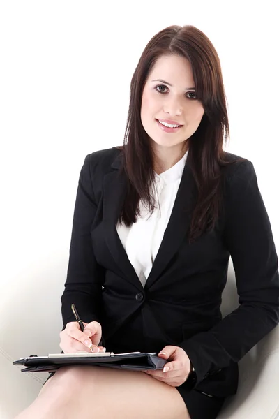 Businesswoman sitting in a chair with a notebook — Stock Photo, Image