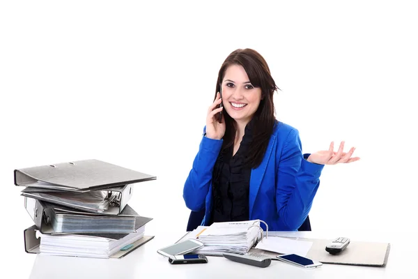 Businesswoman talking on mobile phone while sitting at the table — Stock Photo, Image