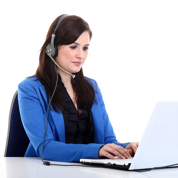 Businesswoman with headphones working on a laptop — Stock Photo, Image