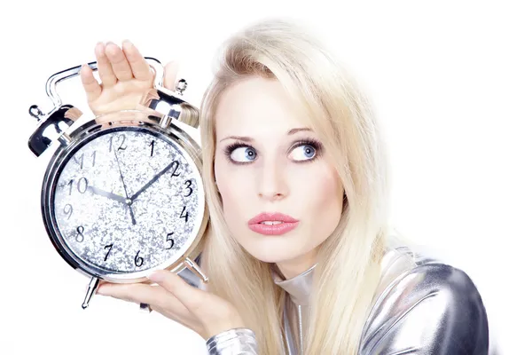 Blonde girl in a silver dress with an alarm clock — Stock Photo, Image