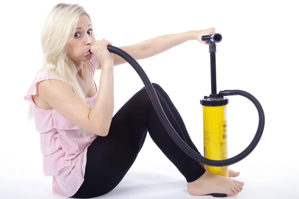 Blonde girl pump inflates itself — Stock Photo, Image