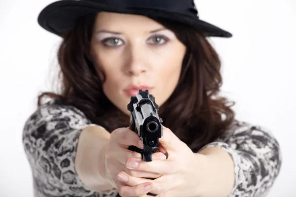 The girl in a hat with a gun — Stock Photo, Image