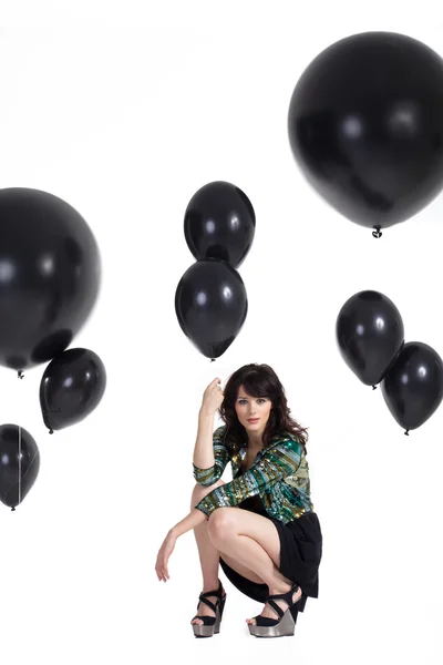 Brunette girl with balloons on a white background — Stock Photo, Image