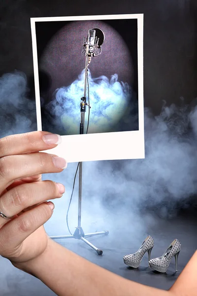 En flicka har en foto studiomikrofon på bakgrund av röken — Stockfoto
