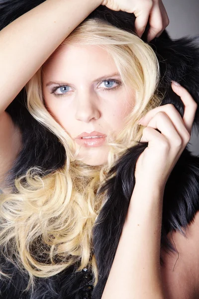 Blonde girl in black fur — Stock Photo, Image