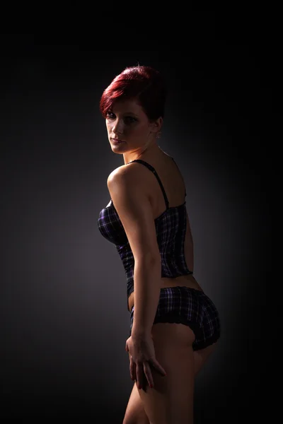 Meisje in lingerie op een zwarte achtergrond — Stockfoto