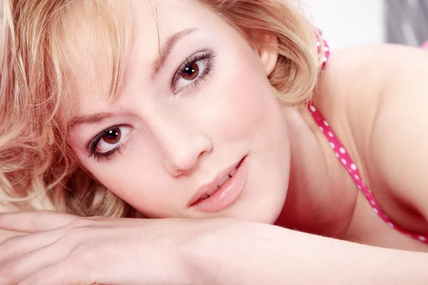 Blonde girl in underwear lying on a bed — Stock Photo, Image