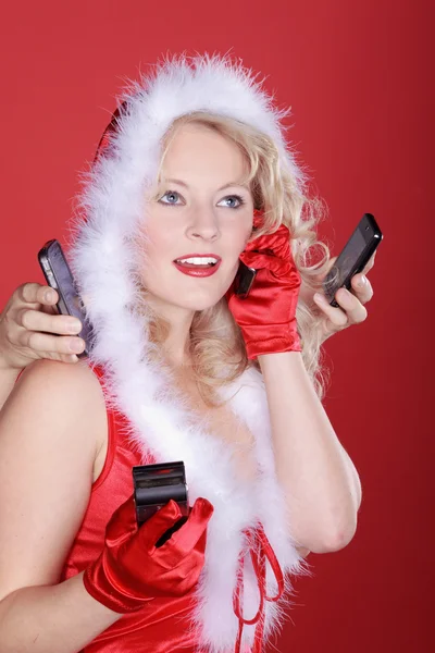 Christmas blonde girl with mobile phones — Stock Photo, Image