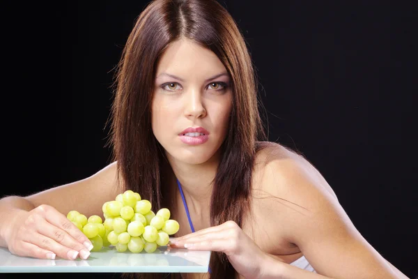 Girl with a branch of grapes — Stock Photo, Image