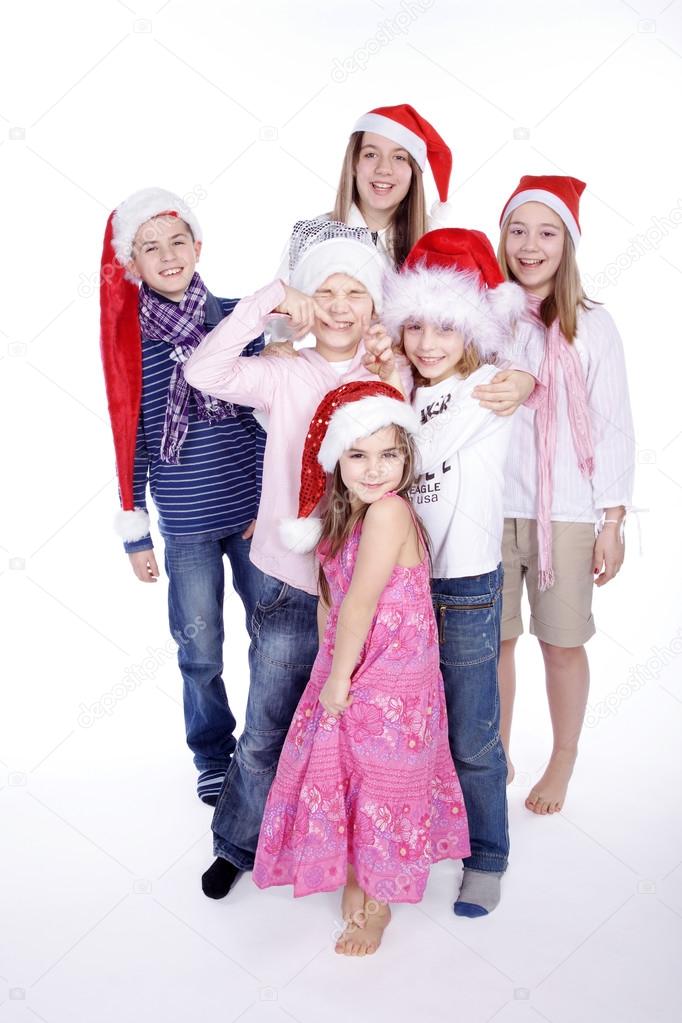 Six children in Christmas hats