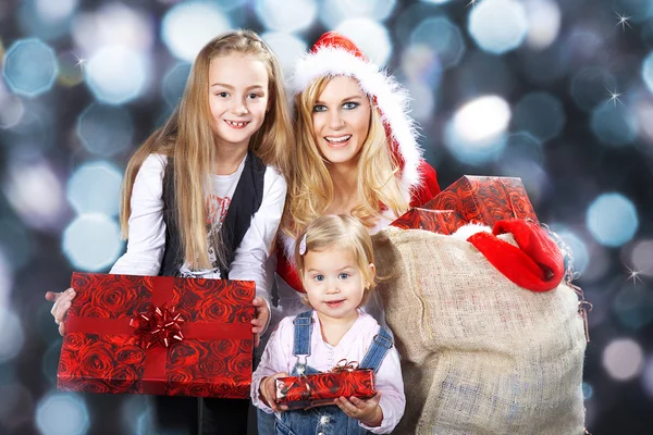 Three happy Christmas girls with gifts — Stock Photo, Image