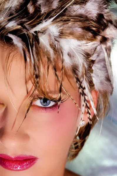 The girl's face with feathers on his head — Stock Photo, Image