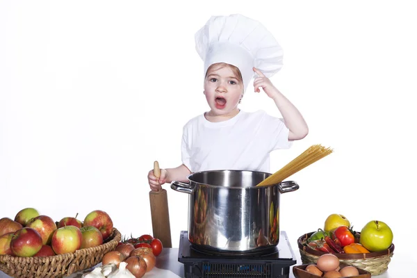 Little girl cooking noodles in a large pot — Stock Photo, Image