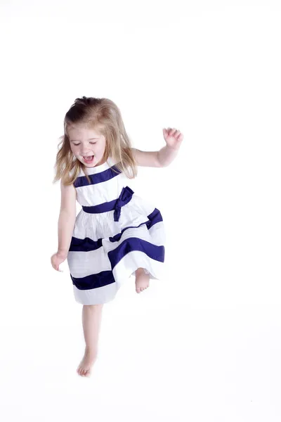 Little girl dancing on a white background — Stock Photo, Image