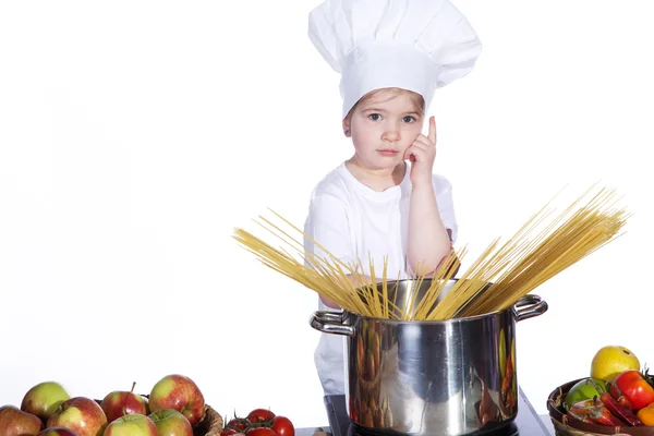 Little girl cooking noodles in a large pot — Stock Photo, Image