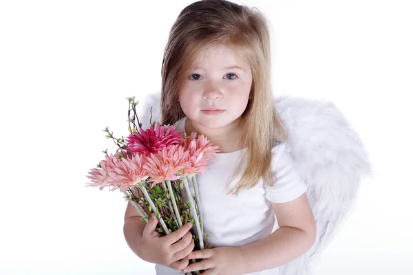 Little girl with angel wings holding a bouquet of flowers — Stock Photo, Image