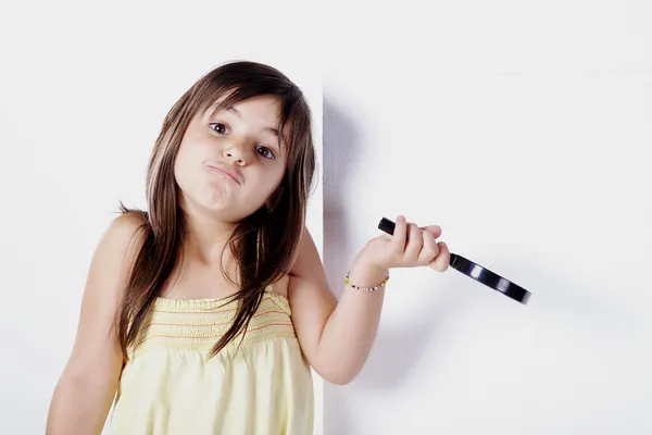 Little girl holding a brush — Stock Photo, Image