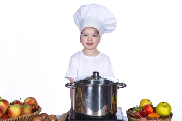 Little girl cooking noodles in a large pot — Stock Photo, Image