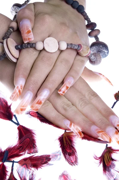 Women's hands with a necklace and feathers — Stock Photo, Image