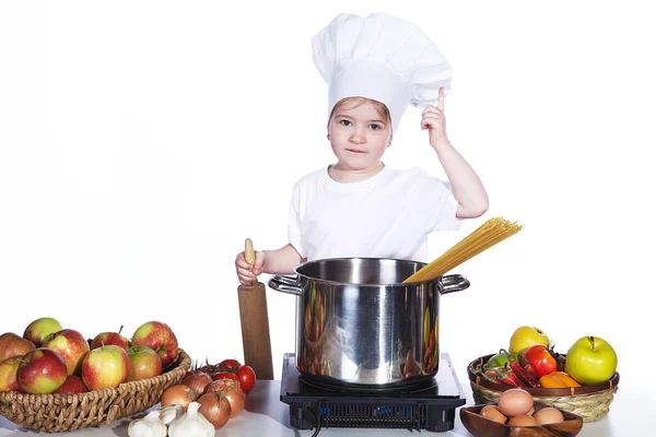 Little girl cooking noodles in a large pot — Stock Photo, Image