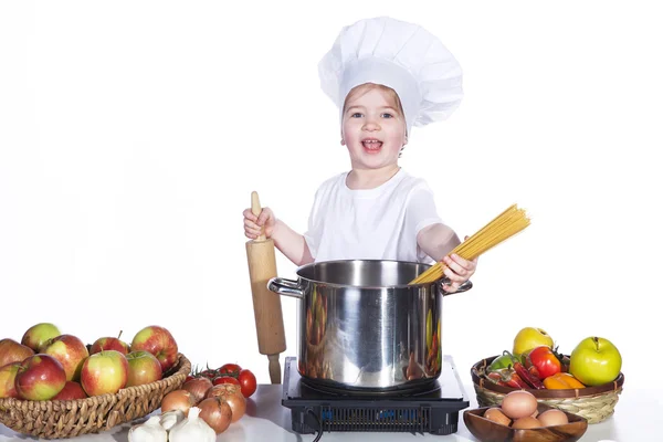 Little girl cooking noodles in a large pot — Stock Photo, Image