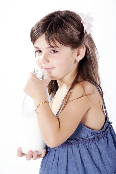 Little girl drinking milk in a plastic bottle — Stock Photo, Image