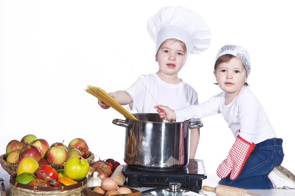 Two little girls are preparing spaghetti — Stock Photo, Image