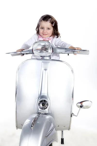 The little girl is sitting on a moped — Stock Photo, Image