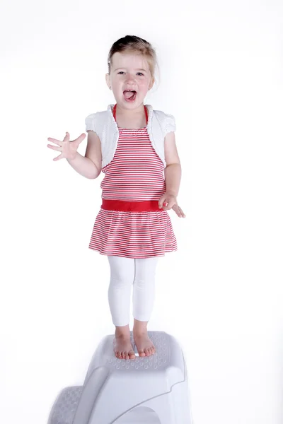 Little girl standing on a chair — Stock Photo, Image