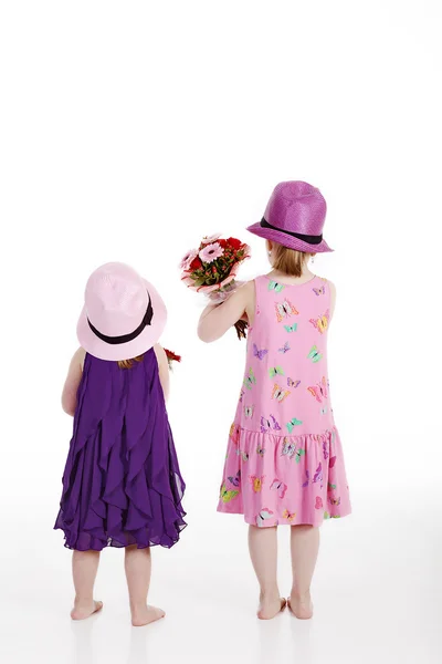 Two girls with a bouquet of flowers Royalty Free Stock Images
