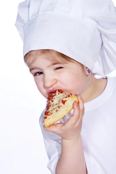 Cook girl eating pizza Royalty Free Stock Images