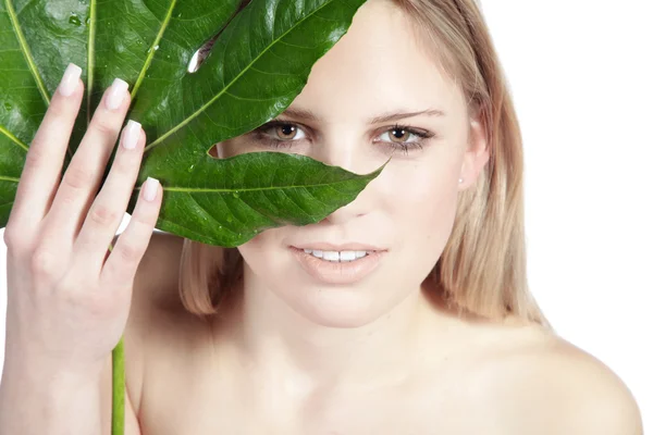 Blonde girl with green leaf — Stock Photo, Image