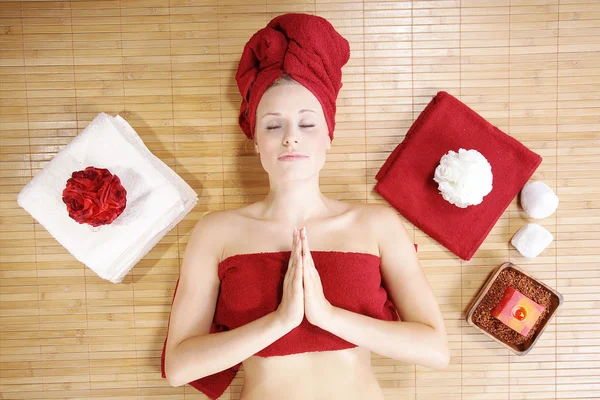 The girl in a red towel lying in massage salon — Stock Photo, Image