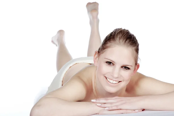 The blonde girl is lying on the massage table — Stock Photo, Image