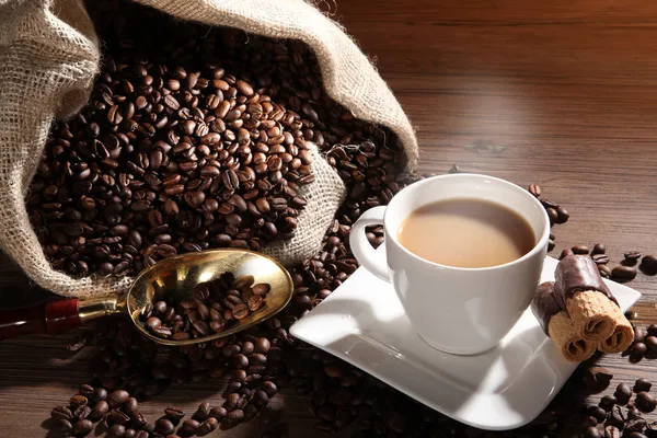 Coffee with sack of coffee beans — Stock Photo, Image